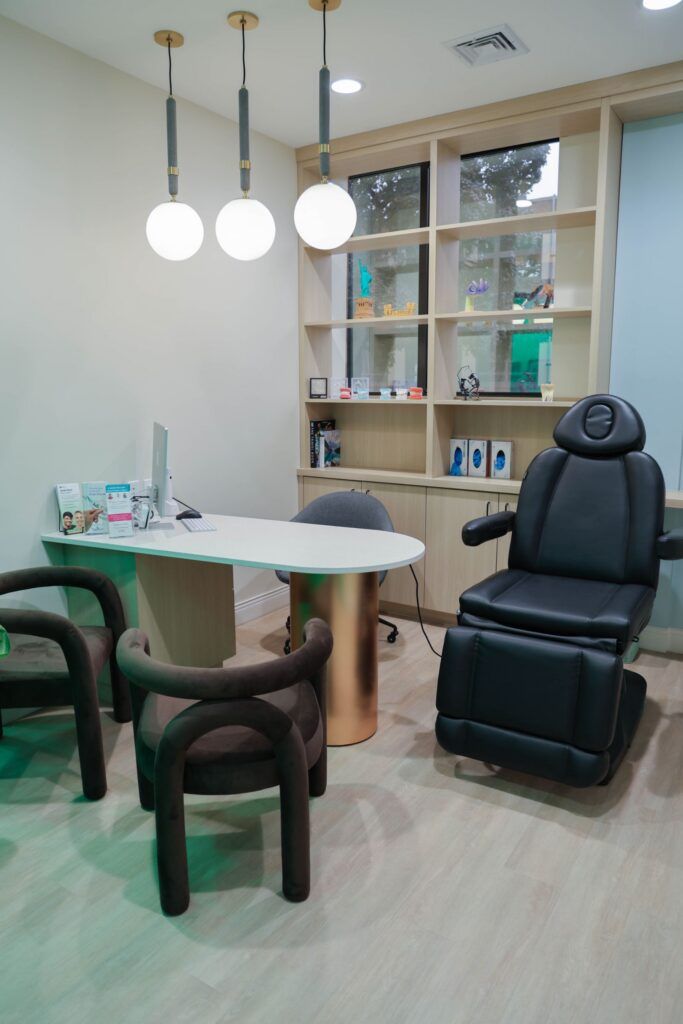 Elite Orthodontics Studio office consultation room with a desk, pendant lights and a treatment chair