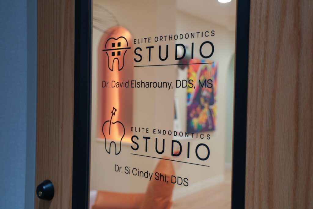 Elite Orthodontics Studio office entrance door with practice logos on the glass
