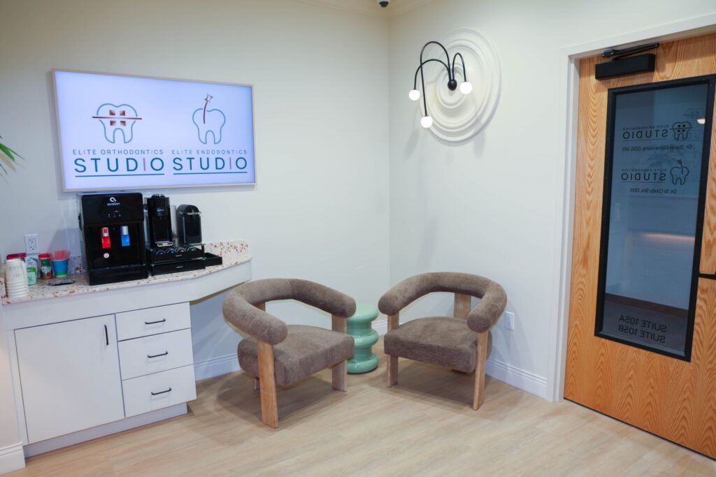 Elite Orthodontics Studio office waiting area with two armchairs and a coffee and water station